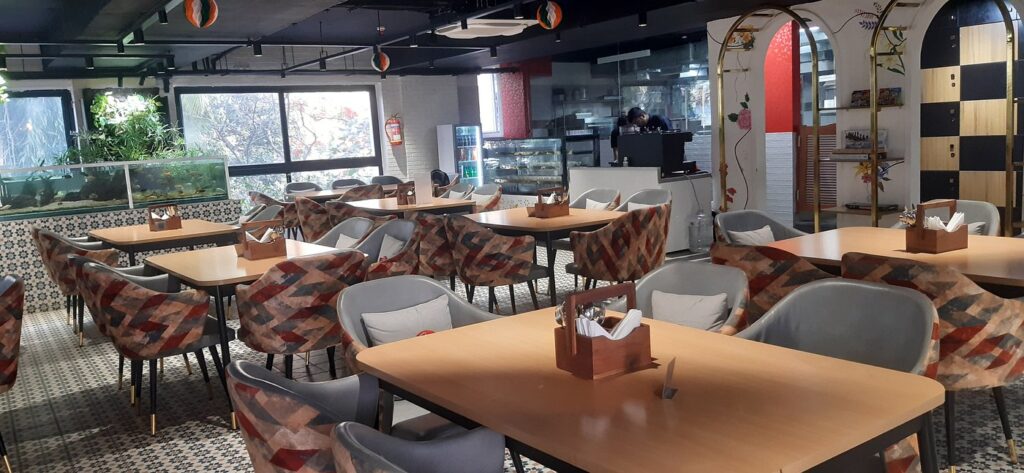 Modern café interior featuring stylish seating, wooden tables, and a cozy atmosphere for dining and coffee.