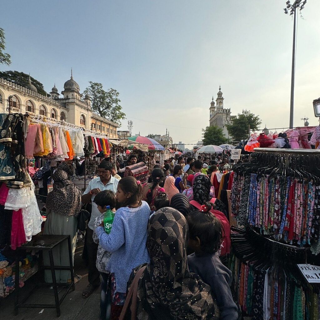 Crowded street market with clothing stalls, one of the best street shopping places in Hyderabad.