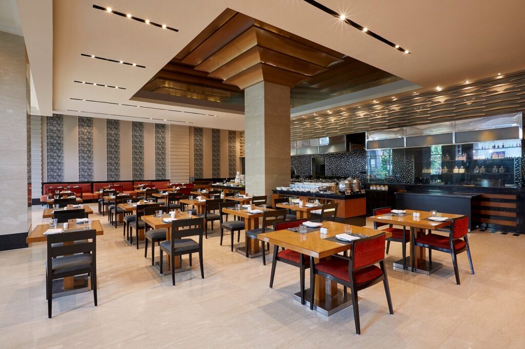 Modern dining area inside MoMo Café, one of the Top 5 Budget-Friendly Cafes in Hyderabad, featuring elegant interiors and comfortable seating.